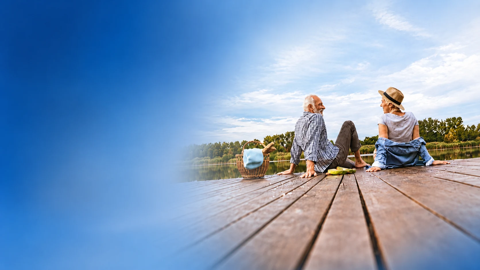 Older couple sharing a relaxed moment on a lakeside dock, near, intermediate and distance vision with the Asqelio intraocular lens